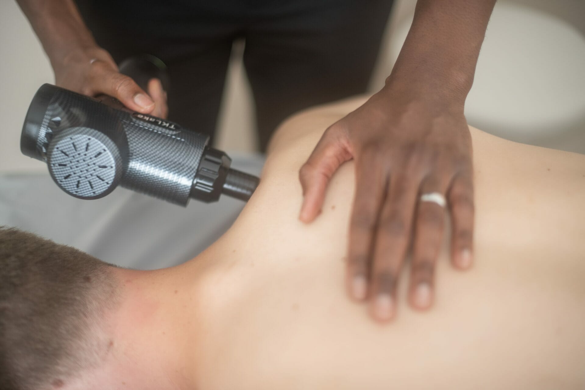 Physio in Sevenoaks uses a Physiotherapy Massage Gun for shoulder treatment