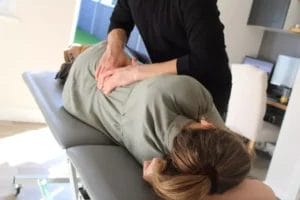 Osteoapath providing a deep tissue massage to lower back in Bexley